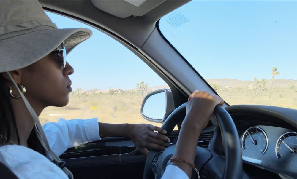 A traveller driving a rental car through open country